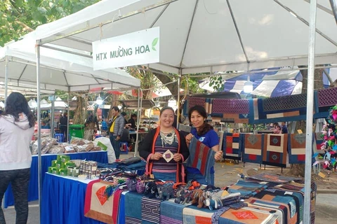 Chị Sùng Thị Lan (trái) quảng bá sản phẩm của hợp tác xã Mường Hoa ở hội chợ. (Ảnh: NVCC)