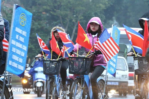 Người dân chuẩn bị cờ hoa đón chờ Chủ tịch Kim Jong-un đến Hà Nội. (Ảnh: Minh Sơn/Vietnam+) 