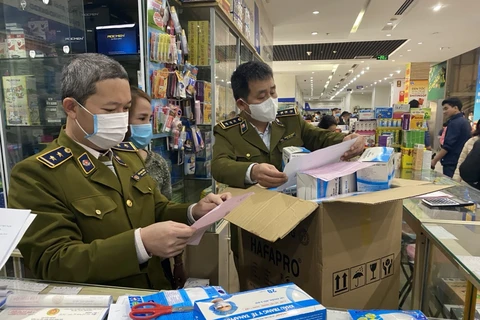 Lực lượng Quản lý thị trường Hà Nội kiểm tra một hiệu thuốc trên địa bàn. (Ảnh: PV/Vietnam+)