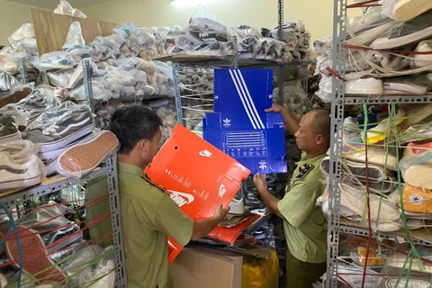 Lực lượng Quản lý thị trường kiểm tra hàng hóa tại cơ sở kinh doanh ngõ 82 Trần Cung, quận Cầu Giấy. (Ảnh: PV/Vietnam+)