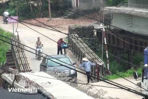 Một nhóm người tự ý lập chốt thu phí đối với ô tô lưu thông qua cây cầu tạm phục vụ công trình xây cầu Hòa Viên. (Ảnh: PV/Vietnam+)