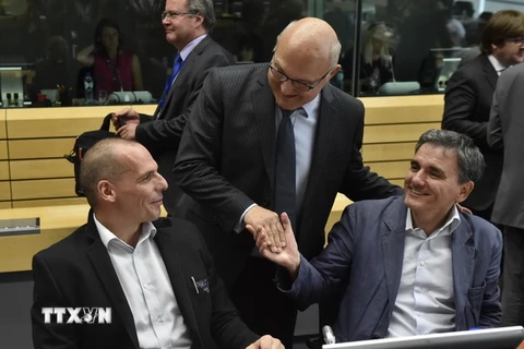 Bộ trưởng Tài chính, Kinh tế và Thương mại Pháp Michel Sapin (giữa) và Bộ trưởng Tài chính Hy Lạp Yanis Varoufakis trước cuộc họp vào ngày 25/6. (Nguồn: AFP/TTXVN)