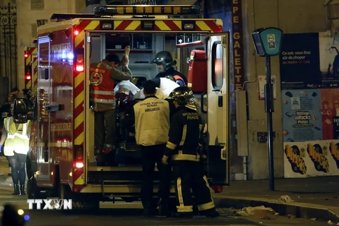 Lực lượng cứu hộ chuyển nạn nhân vụ tấn công khủng bố gần La Belle Equipe, Paris ngày 14/11. (Nguồn: AFP/TTXVN)