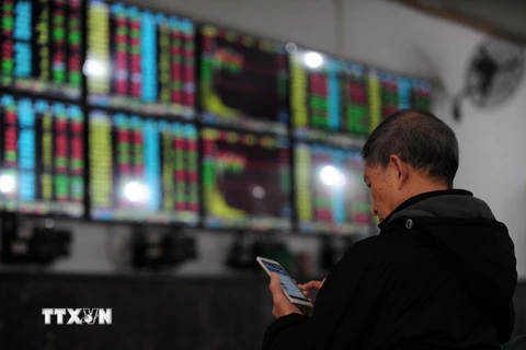 Nhà đầu tư theo dõi tỷ giá chứng khoán tại thành phố Vũ Hán, tỉnh Hồ Bắc, miền trung Trung Quốc ngày 8/1. (Nguồn: AFP/TTXVN)