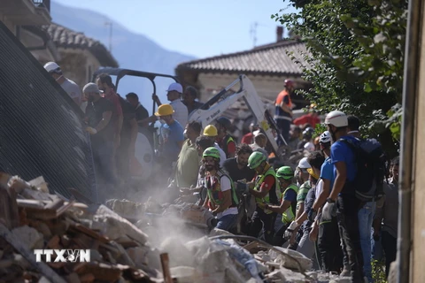 Lực lượng cứu hộ tìm kiếm nạn nhân động đất tại Amatrice, Italy ngày 24/8. (Nguồn: AFP/TTXVN)