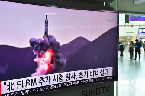 Hình ảnh được phát qua truyền hình tại nhà ga tàu hỏa ở Seoul, Hàn Quốc ngày 9/7 cho thấy Triều Tiên phóng thử tên lửa. (Nguồn: AFP/TTXVN)