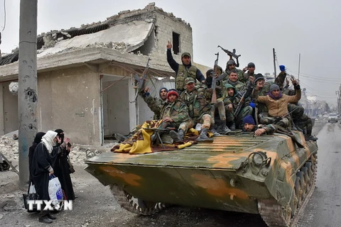 Lực lượng ủng hộ Chính phủ Syria tuần tra qua quận Masaken Hanano, phía đông thành phố Aleppo. (Nguồn: AFP/TTXVN)
