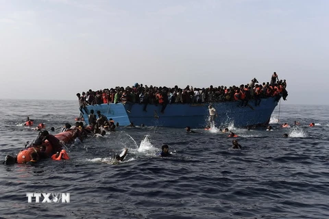 Người di cư chờ lực lượng cứu hộ cứu sau khi tàu của họ bị đắm tại Biển Địa Trung Hải ngày 4/10/2016. (Nguồn: AP/TTXVN)