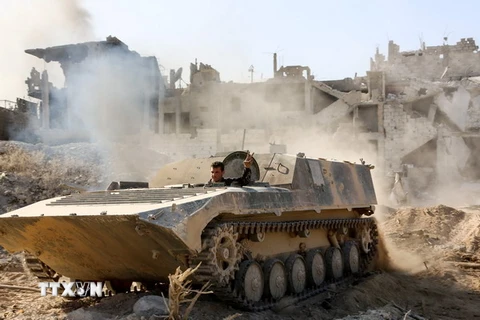 Lực lượng Chính phủ Syria tiến vào thị trấn Qabun ngày 13/5. AFP/TTXVN
