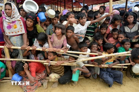 Người tị nạn Rohingya xếp hàng chờ nhận lương thực cứu trợ tại trại tị nạn Thaingkhali ở Ukhia, Bangladeshngày 21/10. (Nguồn: AFP/ TTXVN)