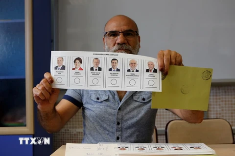 Cử tri Thổ Nhĩ Kỳ cầm lá phiếu bầu tại một địa điểm bầu cử ở Ankara. (Nguồn: THX/TTXVN) 