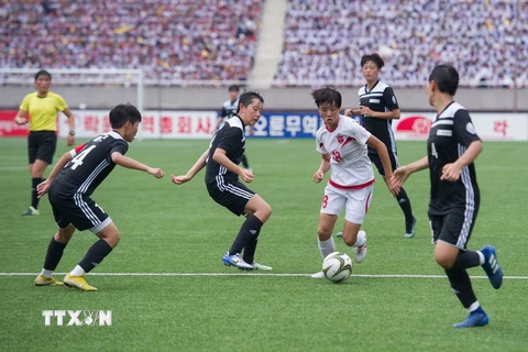 Cầu thủ của đội 25/4 của Triều Tiên (giữa) đi bóng trước các cầu thủ đội KEB Hana của Hàn Quốc trong trận đấu thuộc Giải bóng đá trẻ quốc tế Bình Nhưỡng, Triều Tiên ngày 15/8. (Nguồn: AFP/TTXVN)