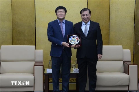 Chủ tịch Ủy ban Nhân dân thành phố Đà Nẵng Huỳnh Đức Thơ (bên phải) tặng quà lưu niệm cho Giám đốc Cơ quan Hợp tác Quốc tế Hàn Quốc tại Việt Nam Kim Jinoh (bên trái). (Ảnh: Quốc Dũng/TTXVN) 