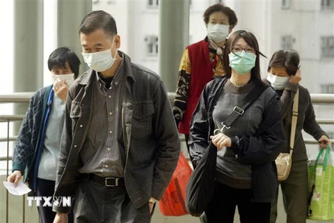 Người dân đeo khẩu trang để ngăn ngừa lây nhiễm hội chứng viêm đường hô hấp cấp (SARS) tại Hong Kong, Trung Quốc, tháng 1/2004. (Nguồn: AFP/TTXVN) 
