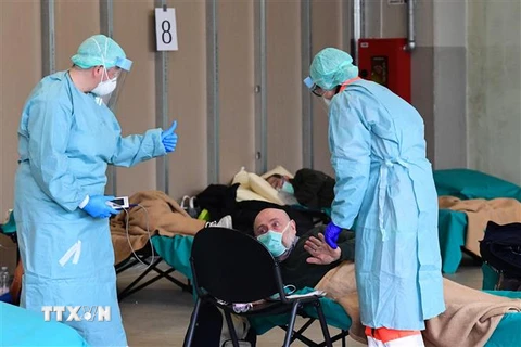 Nhân viên y tế điều trị cho bệnh nhân mắc COVID-19 tại một bệnh viện dã chiến ở vùng Lombardy, Italy ngày 13/3/2020. (Nguồn: AFP/TTXVN) 