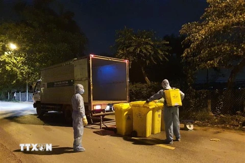 Thu gom rác thải tại thôn Hạ Lôi để xử lý theo quy trình rác thải y tế. (Ảnh: Mạnh Khánh/TTXVN) 