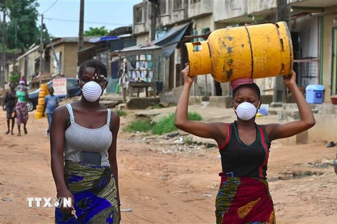 Người dân đeo khẩu trang nhằm ngăn chặn sự lây lan của dịch COVID-19 tại Abidjan, Cote d'Ivoire ngày 25/3/2020. (Nguồn: AFP/TTXVN) 