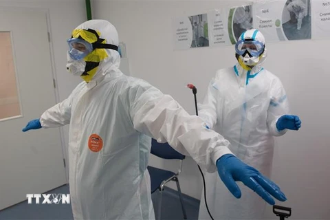 Nhân viên y tế khử trùng quần áo bảo hộ tại khu vực điều trị bệnh nhân COVID-19 ở Moskva, Nga, ngày 14/5/2020. (Nguồn: THX/TTXVN) 