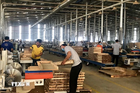 Sản xuất đồ gỗ tại Công ty Trách nhiệm hữu hạn Một thành viên Triệu Phú Lộc, thị xã Tân Uyên. (Ảnh: Chí Tưởng/TTXVN)