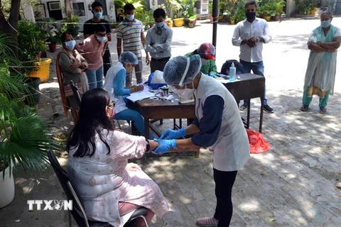 Nhân viên y tế lấy máu xét nghiệm COVID-19 cho người dân tại New Delhi, Ấn Độ, ngày 6/8/2020. (Nguồn: THX/TTXVN) 