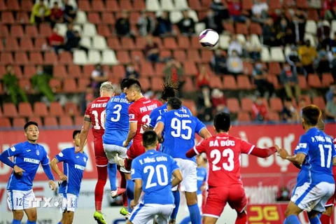 Pha tranh bóng trên không của các cầu thủ Than Quảng Ninh (áo xanh) và Hải Phòng trên Sân vận động Lạch Tray. (Nguồn: TTXVN) 