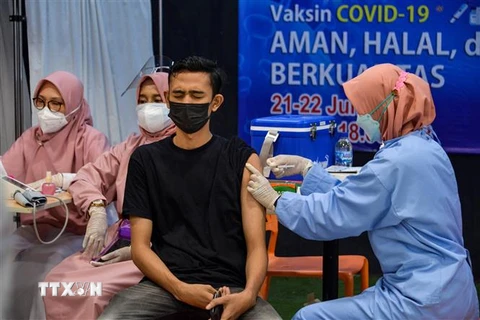 Nhân viên y tế tiêm vaccine phòng COVID-19 cho người dân tại Banda Aceh, Indonesia ngày 22/7/2021. (Ảnh: AFP/TTXVN) 