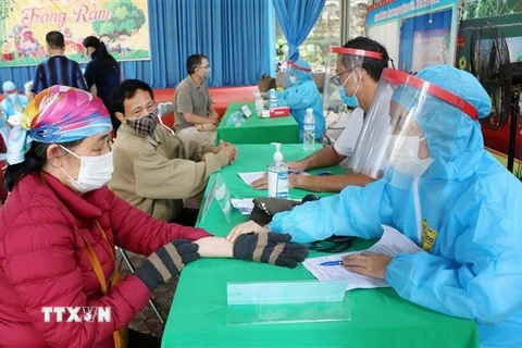 Nhân viên y tế kiểm tra sức khỏe người dân thành phố Việt Trì trước khi tiêm vaccine. (Ảnh: Trung Kiên/TTXVN) 