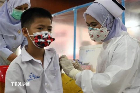 Nhân viên y tế tiêm vaccine ngừa COVID-19 cho học sinh tại tỉnh Pattani, miền Nam Thái Lan. (Ảnh: AFP/TTXVN) 