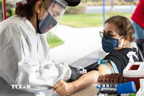 Nhân viên y tế tiêm vaccine phòng COVID-19 cho người dân tại Santa Monica, California. (Ảnh: AFP/TTXVN) 