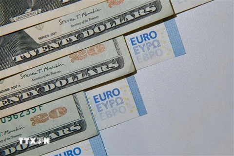 Đồng euro (phải) và đồng USD tại Madrid, Tây Ban Nha, ngày 11/7/2022. (Ảnh: THX/TTXVN) 
