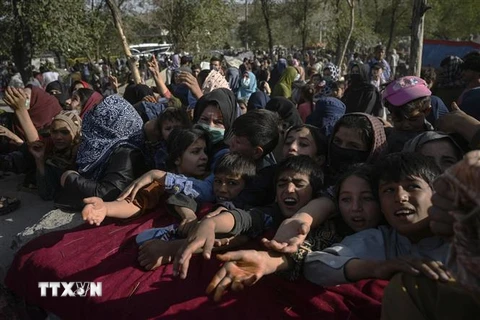 Người Afghanistan, sơ tán khỏi tỉnh Takhar để tránh xung đột, chờ nhận lương thực viện trợ tại Kabul. (Ảnh: AFP/TTXVN) 