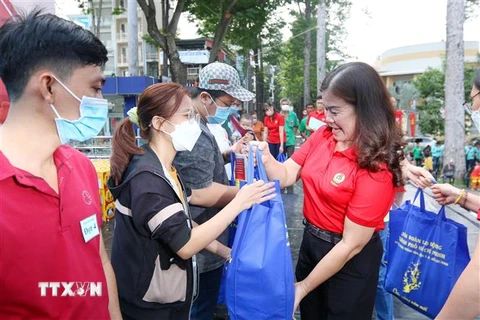 Chủ tịch Liên đoàn Lao động quận 5 Thành phố Hồ Chí Minh Lê Thị Bích Hạnh tặng quà Tết cho công nhân có hoàn cảnh khó khăn vào ngày 8/1/2023. (Ảnh: Thanh Vũ/TTXVN)