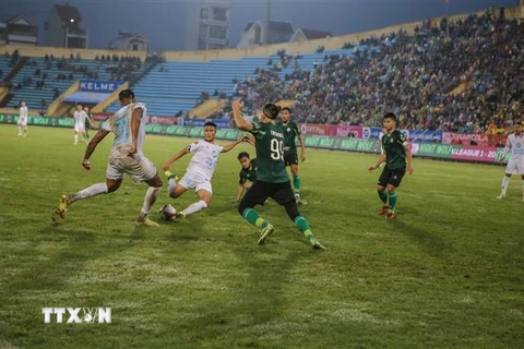 Tình huống bóng nguy hiểm trong trận đấu giữa Câu lạc bộ Thép Xanh Nam Định (áo trắng) và Câu lạc bộ Thành phố Hồ Chí Minh. (Ảnh: Công Luật/TTXVN)