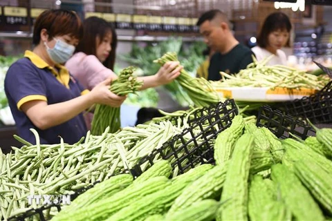 Người tiêu dùng mua hàng tại một chợ ở Hồ Nam, Trung Quốc. (Ảnh: THX/TTXVN)