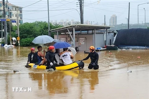 Lực lượng cứu hộ sơ tán người dân khỏi khu vực ngập lụt ở thành phố Gongju, Hàn Quốc ngày 15/7/2023. (Ảnh: Yonhap/TTXVN)