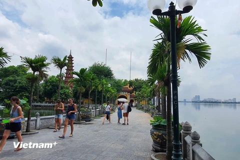 Du khách nước ngoài tham quan chùa Trấn Quốc, Tây Hồ, Hà Nội. (Ảnh: Huy Khánh/Vietnam+)