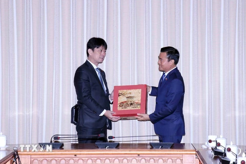 Phó Chủ tịch Ủy ban Nhân dân Thành phố Hồ Chí Minh Bùi Xuân Cường (phải) trao quà đối ngoại cho Thứ trưởng Bộ Ngoại giao Nhật Bản Komura Masahiro. (Ảnh: Xuân Khu/TTXVN)