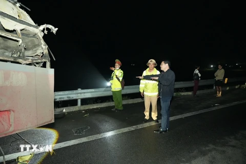 Phó Chủ tịch Ủy ban Nhân dân tỉnh Thừa Thiên-Huế Hoàng Hải Minh (áo đen) kiểm tra hiện trường vụ tại nạn. (Ảnh: TTXVN phát)