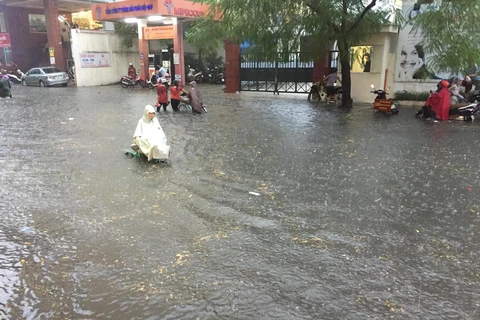 Khoảng 16h ngày 26/9, cơn mưa tầm tã kéo dài nhiều giờ tại nhiều quận nội thành Hà Nội khiến một loạt tuyến đường bị ngập sâu biến thành sông. (Ảnh: PV/Vietnam+) 