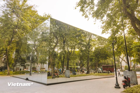 Những ngày qua, nhiều người dân đi qua khu vực vườn hoa Diên Hồng đều bất ngờ khi thấy một công trình bằng gương được dựng lên tạo thành một điểm nhấn độc đáo giữa trung tâm quận Hoàn Kiếm (Hà Nội). (Ảnh: Minh Sơn/Vietnam+)