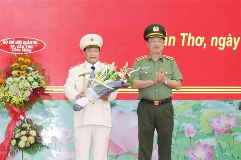 Thứ trưởng Nguyễn Văn Thành trao Quyết định và tặng hoa chúc mừng Đại tá Nguyễn Văn Thuận. (Nguồn: Thanh Sang/TTXVN)