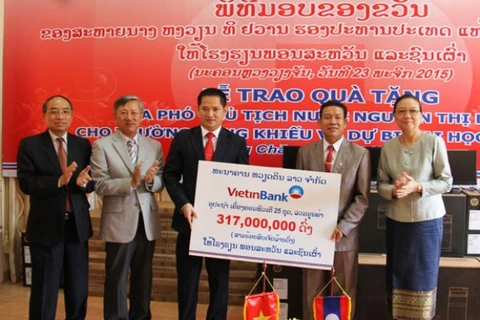 Ông Lê Quốc Nam - Tổng Giám đốc VietinBank Lào (thứ ba từ trái sang) trao từ thiện tại Trường năng khiếu - dự bị đại học. (Nguồn: VietinBank)