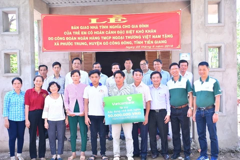Lãnh đạo Vietcombank trao nhà tình nghĩa cho gia đình ông Cường. (Nguồn: Vietcombank)