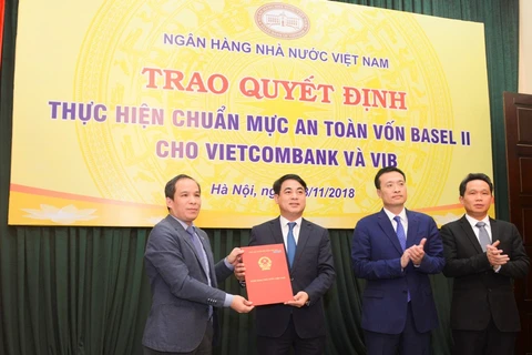 Đại diện NHNN trao quyết định cho lãnh đạo Vietcombank. (Nguồn: CTV)