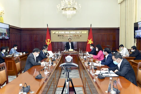 Phó Thống đốc Ngân hàng Nhà nước Đào Minh Tú chủ trì cuộc họp. (Ảnh: CTV/Vietnam+)