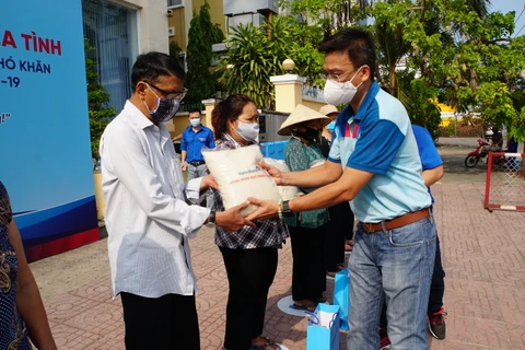 Cán bộ VietinBank trao gạo cho người nghèo tại TPHCM. (Ảnh: Vietnam+)
