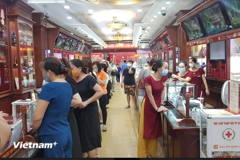 Nhiều người dân xếp hàng mua bán vàng tại Bảo Tín Minh Châu trên phố Trần Nhân Tông, Hà Nội chiều ngày 6/8. (Ảnh: PV/Vietnam+)