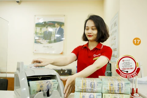 Ngân hàng và doanh nghiệp đều đang ngóng Thông tư 01 được sửa đổi để tránh nợ xấu. (Ảnh: CTV/Vietnam+)