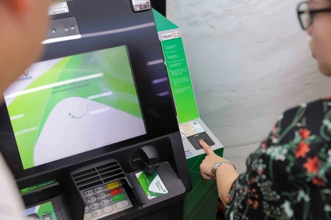 Khách hàng trải nghiệm rút tiền bằng căn cước công dân gắn chip tại ATM của Vietcombank đặt tại chi nhánh Vietcombank Ba Đình, 72 Trần Hưng Đạo, Hoàn Kiếm, Hà Nội. (Ảnh: Vietnam+)