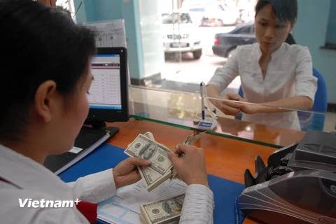 Tỷ giá trung tâm tăng mạnh kéo theo tỷ giá tại các ngân hàng thương mại cũng tăng. (Ảnh: PV/Vietnam+)